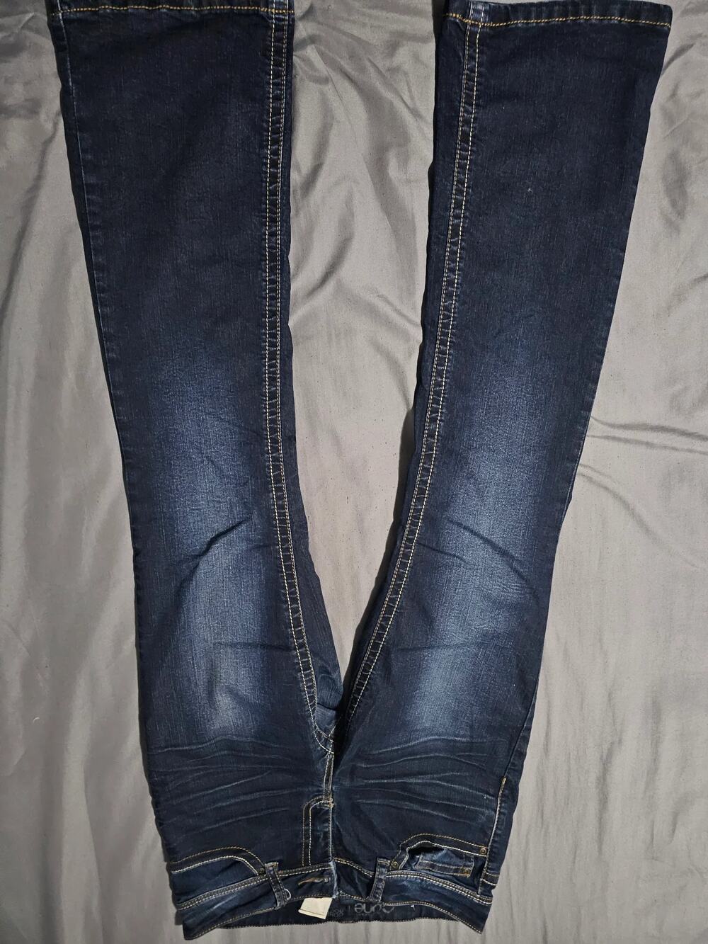 Dark wash skinny jeans contrast stitching faded whiskering five pocket zip fly